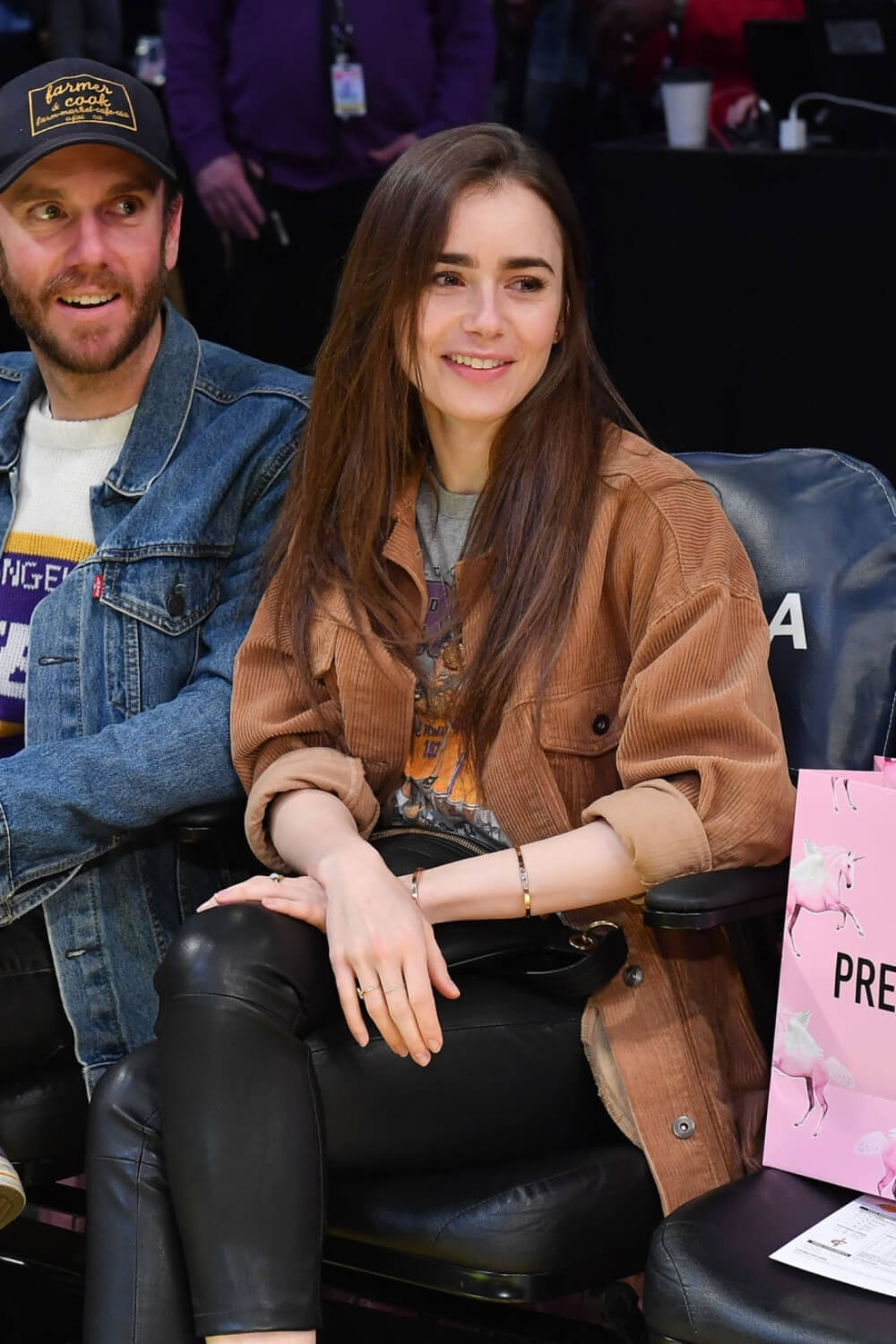 Lily Collins at a Los Angeles Lakers game - Leather Celebrities